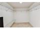 Spacious walk-in closet with white walls and wire shelving for storage and organization at 14820 Rue De Bayonne # 205, Clearwater, FL 33762
