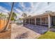 Large backyard includes a swimming pool, screened-in porch, brick patio and wooden fence at 2031 Tanglewood Ne Way, St Petersburg, FL 33702