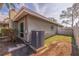 Exterior side view of the home with an AC unit, grass, and small patio at 2031 Tanglewood Ne Way, St Petersburg, FL 33702