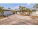 Charming single-story home with a two-car garage, stone accents and well-manicured landscaping at 2031 Tanglewood Ne Way, St Petersburg, FL 33702