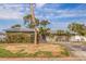 Charming single-story home with stone accents, large driveway, and tropical landscaping at 2031 Tanglewood Ne Way, St Petersburg, FL 33702