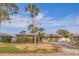 Charming single-story home with stone accents, large driveway, and tropical landscaping at 2031 Tanglewood Ne Way, St Petersburg, FL 33702