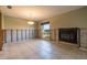 Living area ready for renovation showing a fireplace, tile flooring and large window at 2031 Tanglewood Ne Way, St Petersburg, FL 33702