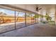 Enclosed patio features a ceiling fan, and a view of the pool and backyard at 2031 Tanglewood Ne Way, St Petersburg, FL 33702