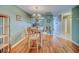 Dining area with wood floors, a wooden table and views into the kitchen with granite countertops at 215 Valencia Blvd # 207, Belleair Bluffs, FL 33770