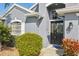 Elegant front entrance featuring a decorative door with sidelight windows and manicured landscaping at 2226 Indian Key Dr, Holiday, FL 34691