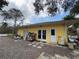 Backyard view of the yellow home with multiple access doors and stone accents at 3112 Desoto Rd, Sarasota, FL 34234