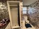Full bathroom features a toilet and enclosed shower, enhanced by unique wallpaper at 3112 Desoto Rd, Sarasota, FL 34234