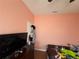 Cozy bedroom featuring bright pink walls, a dark dresser, and playful decor at 3112 Desoto Rd, Sarasota, FL 34234