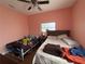 Bright bedroom with two twin beds, a ceiling fan, and natural light from the window at 3112 Desoto Rd, Sarasota, FL 34234