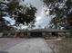Wide front exterior view with a large driveway, landscaping and covered entryway at 3112 Desoto Rd, Sarasota, FL 34234