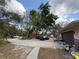 Large driveway with ample parking and stone exterior accents at 3112 Desoto Rd, Sarasota, FL 34234