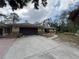 Exterior view with a wide driveway, some brick accents and a two-car garage at 3112 Desoto Rd, Sarasota, FL 34234