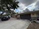 Property featuring a front driveway leading to a two-car garage, surrounded by mature trees at 3112 Desoto Rd, Sarasota, FL 34234