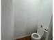 Standard half bathroom features wood-look flooring and a white toilet at 3112 Desoto Rd, Sarasota, FL 34234