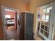 A modern kitchen features a stainless-steel refrigerator and connections to the living room and stairs at 3112 Desoto Rd, Sarasota, FL 34234
