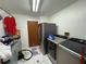 Laundry room with washer, dryer, refrigerator, and cleaning supplies at 3112 Desoto Rd, Sarasota, FL 34234