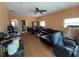 Open-concept living room features laminated wood floors, a black sectional sofa, and a dining area at 3112 Desoto Rd, Sarasota, FL 34234
