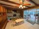 Bright living area featuring a stone fireplace, wooden ceiling beams, and sliding glass doors to the patio at 3112 Desoto Rd, Sarasota, FL 34234