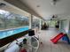 Large screened patio features tile flooring, ceiling fans and access to a refreshing pool at 3112 Desoto Rd, Sarasota, FL 34234