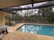 Enjoy the backyard swimming pool with a screened enclosure for outdoor entertaining at 3112 Desoto Rd, Sarasota, FL 34234