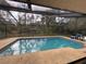 Backyard swimming pool with screened enclosure offers a refreshing escape with backyard views at 3112 Desoto Rd, Sarasota, FL 34234
