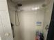 Shower features white tiles, a shower head with hose, and wall-mounted soap dish at 3112 Desoto Rd, Sarasota, FL 34234