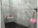 Shower featuring designer grey tile surround and decorative black and white tile on the shower floor at 3112 Desoto Rd, Sarasota, FL 34234
