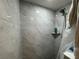 Modern shower design with light-colored marble tiling and a shower head with a matching shelf at 3112 Desoto Rd, Sarasota, FL 34234