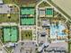 Aerial view showcases community amenities including swimming pool, tennis courts, playground and bocce ball at 31837 Cannon Rush Dr, San Antonio, FL 33576