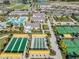 Aerial view showcasing community amenities including pools, tennis courts, and bocce ball at 31837 Cannon Rush Dr, San Antonio, FL 33576