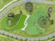 Aerial view of a community water feature showcasing innovative landscape design and roadways at 31837 Cannon Rush Dr, San Antonio, FL 33576