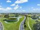 Aerial view of community landscape, showcasing greenspace, ponds, and modern architecture at 31837 Cannon Rush Dr, San Antonio, FL 33576
