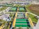 Aerial view of community featuring bocce ball courts, tennis courts, and lush landscaping at 31837 Cannon Rush Dr, San Antonio, FL 33576