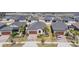 Stunning aerial view of a neighborhood showcasing well-maintained homes, manicured lawns and neighborhood pond at 31837 Cannon Rush Dr, San Antonio, FL 33576