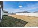A spacious backyard enclosed by a white vinyl fence, offering privacy and room for outdoor activities at 31837 Cannon Rush Dr, San Antonio, FL 33576