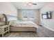 Spacious bedroom with plush carpet, ceiling fan, and a comfortable bed with floral bedding at 31837 Cannon Rush Dr, San Antonio, FL 33576