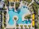 Aerial view of the community pool with ample seating and lounging options and yellow cabanas at 31837 Cannon Rush Dr, San Antonio, FL 33576