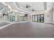 Bright fitness center featuring mirrored walls, ceiling fans, and glass doors at 31837 Cannon Rush Dr, San Antonio, FL 33576