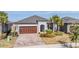 Charming single-story home with a brick driveway, two car garage, and beautifully landscaped front yard at 31837 Cannon Rush Dr, San Antonio, FL 33576