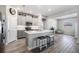 Bright open kitchen with stainless steel appliances, gray cabinetry, and a center island with barstool seating at 31837 Cannon Rush Dr, San Antonio, FL 33576