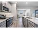 Modern kitchen with stainless steel appliances and gray cabinets provides a sleek and functional space at 31837 Cannon Rush Dr, San Antonio, FL 33576