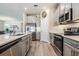 This modern kitchen features stainless steel appliances and gray cabinets, perfect for cooking and entertaining at 31837 Cannon Rush Dr, San Antonio, FL 33576