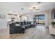 Spacious living room with sliding glass doors to the backyard, open to the kitchen, and featuring stylish gray flooring at 31837 Cannon Rush Dr, San Antonio, FL 33576
