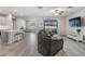 Open-concept living room features tile floors, modern furnishings, and natural light from sliding glass doors at 31837 Cannon Rush Dr, San Antonio, FL 33576