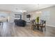 Living area with stylish gray flooring, dining area, and an abundance of natural light from large windows at 31837 Cannon Rush Dr, San Antonio, FL 33576
