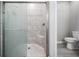 Modern walk-in shower features tiled walls, glass enclosure, and a convenient built-in seat at 31837 Cannon Rush Dr, San Antonio, FL 33576