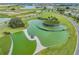 Unique water feature with a tiered design surrounded by lush greenery and walking paths at 31837 Cannon Rush Dr, San Antonio, FL 33576