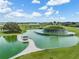 Beautiful lake and water feature within the community with sidewalks, trees, and picnic gazebo at 31837 Cannon Rush Dr, San Antonio, FL 33576