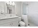 Updated bathroom with white vanity, shower, and modern fixtures at 3218 Fauna St, Sarasota, FL 34235